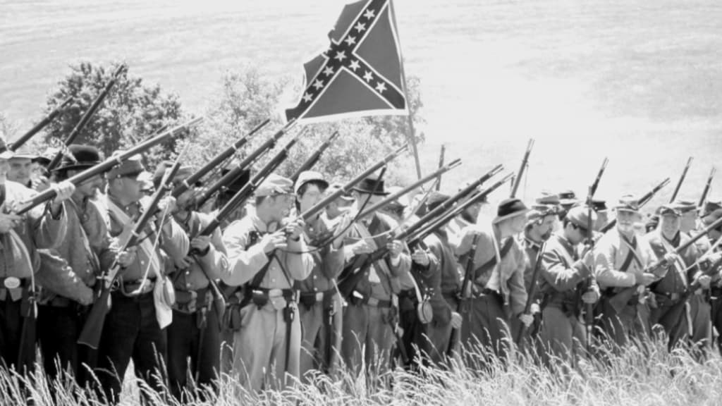 Reenactors posing as Civil War soldiers with a flag