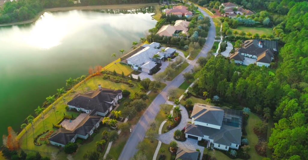 Green area with houses and lake, top view