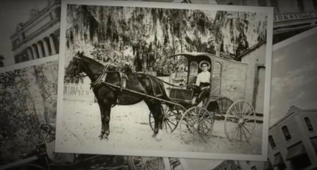 Old photograph of a man in a cart with a horse